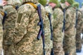 A detachment of soldiers with Kalashnikov assault rifles stand in formation to prepare for battle and offensive