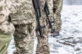 A detachment of soldiers with Kalashnikov assault rifles stand in formation to prepare for battle and offensive