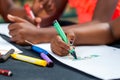 Detail of African kids hands drawing.