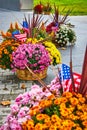 Detail of American flowerpots with oranges, pinks, yellows, and American Flags