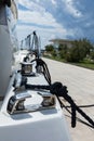 Detail of an anchor rope on a yacht, Stainless steel boat mooring cleat with knotted rope mounted on white yacht deck Royalty Free Stock Photo