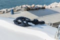 Detail of an anchor rope on a yacht, Stainless steel boat mooring cleat with knotted rope mounted on white yacht deck Royalty Free Stock Photo