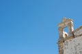 Detail of an ancient building dating back to the 17th century on an all-blue sky, with lots of copyspaces