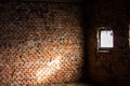 Detail of an ancient red brick wall slightly bleached with salt. Fragments of the narrow white stone windows. The bricks were Royalty Free Stock Photo