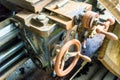 Detail of an ancient rusted and oily lathe in an abandoned industrial hall