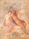 Detail of ancient wall fresco showing a naked young girl aside a greek hero holding medusaÃÂ´s head Royalty Free Stock Photo