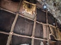 Detail of animal skins hung on the walls of a prehistoric cave.