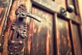 Detail of antique brown wooden door with metal handles Royalty Free Stock Photo