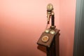 Detail of an antique candlestick telephone on a magenta background. Concept antiques, candlestick phones, calls, communications Royalty Free Stock Photo