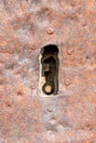 Detail of an antique keyhole in a door veneered with iron plate Royalty Free Stock Photo