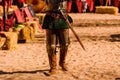 Detail the armor and shield of an actor disguised as a medieval knight in a spring festival for children