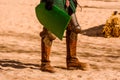 Detail the armor and shield of an actor disguised as a medieval knight in a spring festival for children