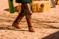 Detail the armor and shield of an actor disguised as a medieval knight in a spring festival for children