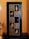 Detail of Art Deco style black lacquered door with Greek key pattern