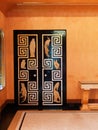 Detail of Art Deco style black lacquered door with Greek key pattern in the dining room at Eltham Palace.