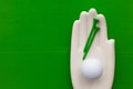 Detail of artifical hand with golf equipments