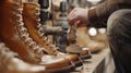 Artisan skillfully handcrafting a classic leather boot in a workshop setting Royalty Free Stock Photo
