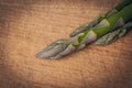 Detail of asparagus tips on wooden cutting board Royalty Free Stock Photo