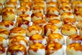 Detail of an assortment of sweet golden toasted burnt sugar panellet cookies on a tray fresh from the gourmet artisan oven.