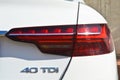 Detail of Audi A4 40 TDI car headlights lamp, white modern car tail red lamp