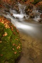 Detail of autumn brook with rocks and leaves Royalty Free Stock Photo