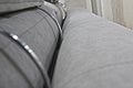 Detail of the back and headrests of the gray velour sofa. Royalty Free Stock Photo