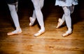 Detail of ballet dancers& x27; feet of three girls standing in special position on wooden floor Royalty Free Stock Photo