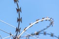 Detail of a barbed wire against blue sky