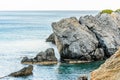 Detail of Bare Rocks with Scars Because of the Low Tide at Preveli Beach in the Island of Crete, Greece. Calm Greek Sea. Royalty Free Stock Photo