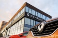 The detail of barge and frontal part of orange Renault Captur SUV in front of the Dacia - Renault dealership which sells these