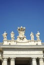 Detail from baroque Saint Peter`s colonnade with beautiful statues of saints and Pope Alexander VII coat of arms. Vatican City