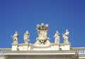 Detail from baroque Saint Peter`s colonnade with beautiful statues of saints and Pope Alexander VII coat of arms. Vatican City Royalty Free Stock Photo