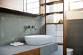 Detail of bathroom in rough concrete grey style