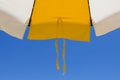 Detail of a beach umbrella with lace on the bottom of the blue s Royalty Free Stock Photo