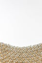 Detail of a beaded collar with faux pearls against a white background