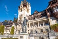 Detail of beautiful Peles Castle in Sinaia with the statue of King Carol I of Romania in front. Royalty Free Stock Photo