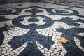 Detail of the beautiful Portuguese pavement at the Liberdade Avenue in the city of Lisbon, Portugal, with dry leaves