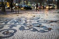 Detail of the beautiful Portuguese pavement at the Liberdade Avenue in the city of Lisbon, Portugal, with dry leaves