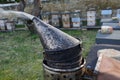 detail of beekeeper smoker to calm bees in hive with metal smoke early in the morning