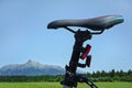 Detail on bike saddle, with green meadow and mountains mount Krivan in background - cycling in country concept Royalty Free Stock Photo
