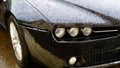 Detail of black Alfa Romeo with the characteristic shield radiator in the rain. Founded on June 24, 1910 in Milan as A.L.F.A Royalty Free Stock Photo