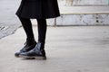 Detail of black booties on the street Royalty Free Stock Photo