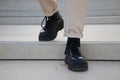 Detail of black boots of man walking down stairs Royalty Free Stock Photo