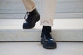 Detail of black boots of man walking down stairs Royalty Free Stock Photo