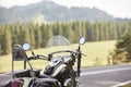 Detail of black shiny high-speed motorcycle parked on roadside on blurred sunny outdoors background. Royalty Free Stock Photo