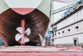 Detail of black stern and ship propeller, rudder in shipyard Royalty Free Stock Photo