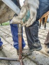 Detail of blacksmith work. Stableman modify hoof Royalty Free Stock Photo