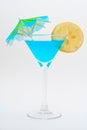 Detail of blue cocktail with lemon and umbrella Royalty Free Stock Photo