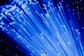 Detail of blue growing bunch of optical fibers background, fast