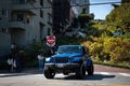 blue Jeep Wrangler driving down Lombard Street